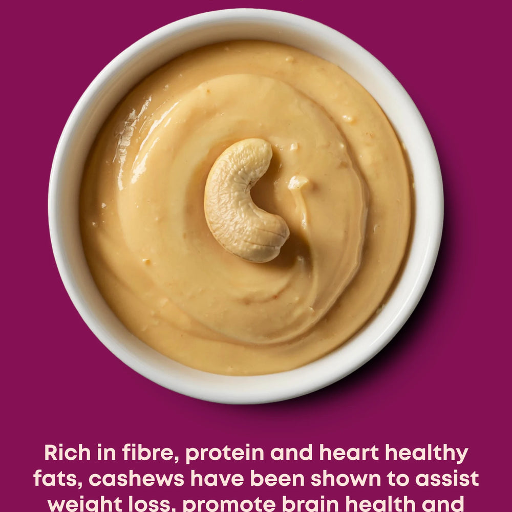 A small white bowl of cashew butter, topped with a whole cashew. Including description of health benefits.